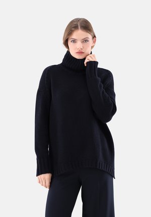 Marinefarbener Rollkragenpullover aus grob gestricktem Material mit lockerer Passform, Rippbündchen und Saum. Die weiche Textur sorgt für Wärme und Komfort.