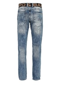 Blue denim jeans with a faded finish, featuring a black waistband with logo, five pockets, and a straight leg design.
