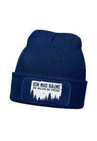 Navy knit beanie with a thick ribbed texture, featuring a rectangular patch with a white graphic and German text about trees.