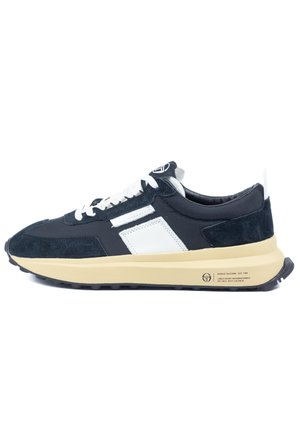 Sneakers feature a navy suede and textile upper, white leather accents, a padded collar, and a beige rubber sole with textured tread.