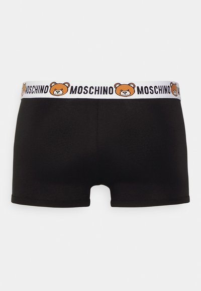 Melni bokseršorti ar baltu jostasvietu, uz kuriem attēloti multfilmu lāči un virs lāču galvām izdrukāta "Moschino" teksts.