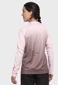 Long-sleeve shirt featuring a gradient from light pink to brown, mesh texture, and a printed message on the back in dark brown.