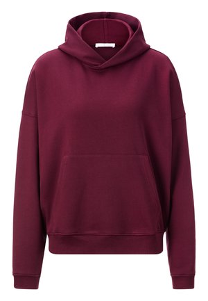 Felpa bordeaux realizzata in morbido tessuto testurizzato. Presenta una ampia tasca frontale, vestibilità oversize e un cappuccio regolabile con cordino.