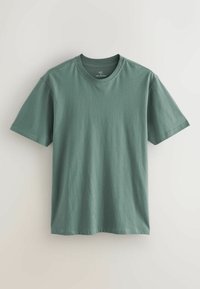 T-shirt en coton vert avec un col rond, des manches courtes et une coupe décontractée. Texture lisse et sans motifs ni accents visibles.