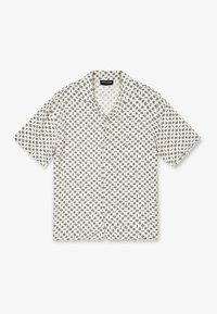 Camicia a maniche corte con bottoni, realizzata in tessuto beige con motivo geometrico nero ripetuto. Colletto con risvolto, vestibilità rilassata e orlo dritto.