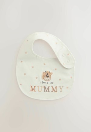 Kreemikreemist puuvillane bib, millel on virsiku värvi tähed, ning mis sisaldab broderitud kaelkirjaku nägu ja teksti "ma armastan oma EMAD" pruuni värviga.