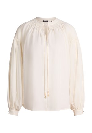 Blusa color avorio a maniche lunghe con scollo arricciato, vestibilità morbida, coulisse con dettagli dorati e polsini con bottoni.