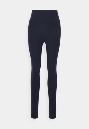 Marine leggings med høy midje, glatt tekstur og figurnær design uten synlige mønstre eller detaljer.