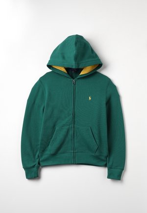 Sudadera verde con capucha y cremallera, forro interior amarillo, puños acanalados y bolsillos tipo canguro. Presenta un pequeño logo en el pecho.