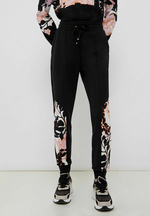 Tracksuit bottoms - orange black flowers