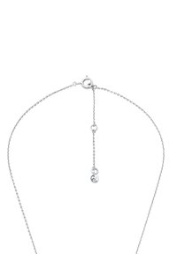 Srebrny naszyjnik łańcuszkowy o delikatnym wzorze, z okrągłym zapięciem i regulowanym łańcuszkiem przedłużającym z małym charms'em na końcu.