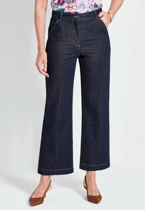 Pantalons en denim bleu foncé à jambes larges avec une taille haute, présentant des poches avant, des coutures ton sur ton et une finition lisse.