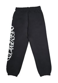 Pantaloni sportivi neri con elastico in vita e polsini, caratterizzati da testo in stile graffiti bianco in verticale lungo la gamba sinistra.