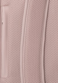 Mjuk rosa nätväv med små perforeringar och en slät accent. Har en vävd rep-liknande kant och integrerad ficka.