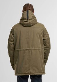 Olive green, thigh-length jacket with a hood, featuring a cinched waist and a black accent strap on the back. Textured fabric with stitching details.