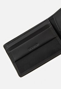 Black leather wallet interior featuring card slots, textured fabric panel, and embossed "BOGNER" logo. Stitching is neat and minimal.