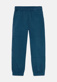 Pantalons légers bleus avec une taille élastique, des poignets fuselés et des détails de panneaux cousus. Fabriqués en tissu doux et froissé.