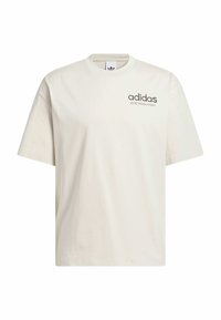 Light beige cotton t-shirt with a crew neckline, short sleeves, and "adidas" logo in dark grey on the left chest. Soft texture.