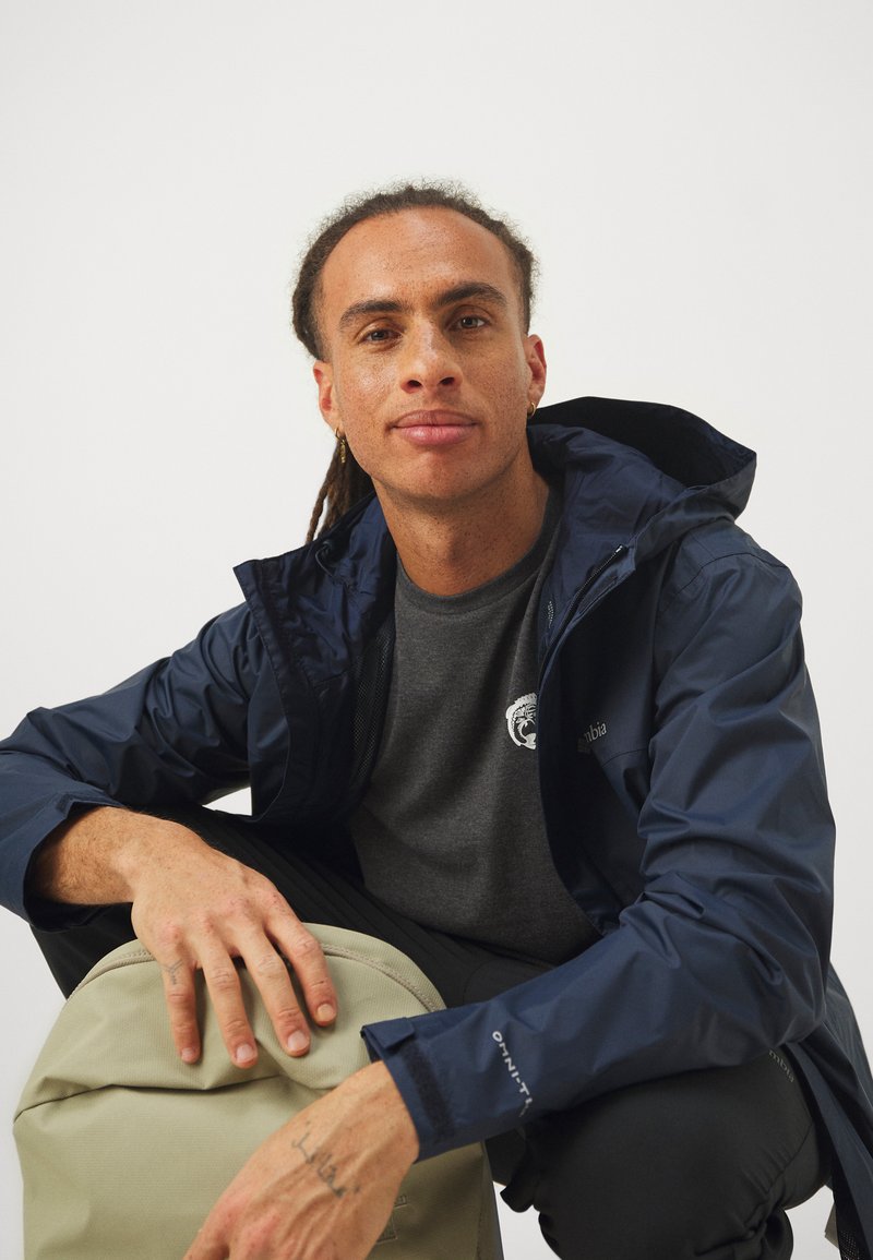 Veste imperméable Columbia bleu et blanche omni