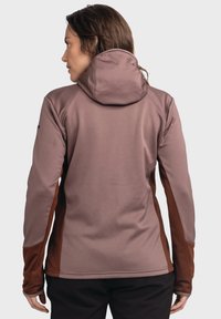 Engelmannes Kapuzenshirt in sanftem Mauve mit braunen seitlichen Einsätzen. Texturiert, lange Ärmel mit Daumenlöchern und entspannter Kapuzendesign.