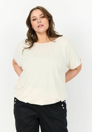 Light beige short-sleeve top with a relaxed fit, round neckline, and subtle pleating. Soft fabric with a smooth texture and casual design.