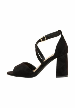 Black suede high-heeled sandal with a peep-toe design, crossed ankle straps, and a chunky block heel featuring a smooth finish.