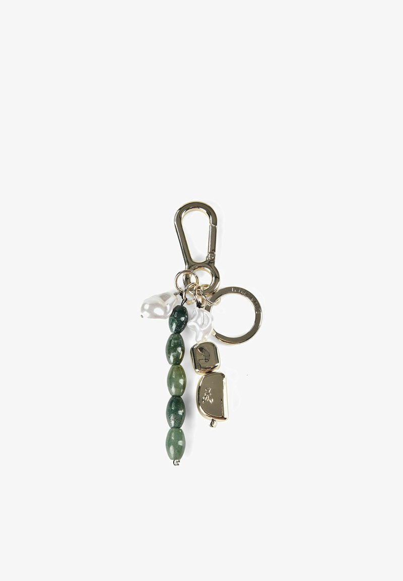 Gold keychain with a clip, featuring green stone beads, two white pearls, and two gold charms, one engraved with a bee.