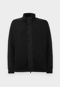 Veste noire avec col haut, boutons-pression et panneaux en tissu contrastant. Comprend deux poches latérales et des poignets côtelés pour un look ajusté.