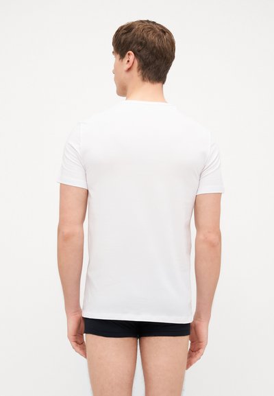 White, short-sleeve t-shirt made of soft cotton. Back view shows a crew neckline and a smooth, unadorned surface. Fitted style.