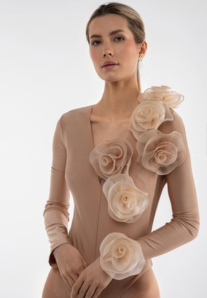 Nackter Ganzkörperanzug mit langen Ärmeln, der große durchsichtige beige Stoffrosen enthält, die eine Schulter schmücken und Textur sowie Dimension verleihen.