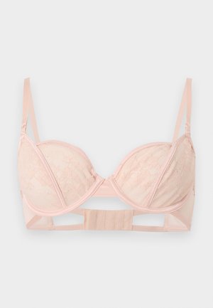Soutien-gorge en dentelle rose clair avec armatures, bretelles réglables et fermeture à agrafes sur un fond uni.