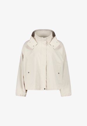 Krótka beżowa kurtka wykonana z gładkiej tkaniny. Posiada wysoki kołnierz, zatrzaski oraz dwie boczne kieszenie, o prostym kroju i luźnym fasonie.