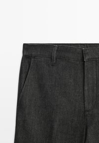 Black denim trousers with a straight-leg design, featuring two side pockets and a flat waistband with belt loops. Subtle texture visible.