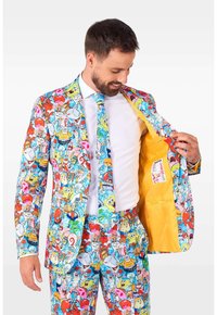 Colorful suit featuring cartoon characters on fabric; outer layer has blue, pink, and red patterns, with a yellow interior lining and matching tie.