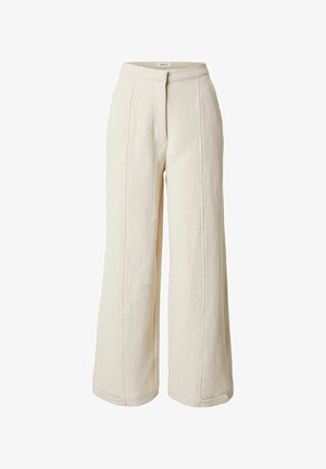 Cremefarbene, weit geschnittene Hose mit hoher Taille und sichtbaren vertikalen Nähten, hergestellt aus strukturiertem Stoff.
