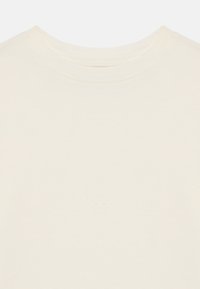 Krém színű, rövid ujjú póló kerek nyakkivágással, puha pamut anyagból készült, sima textúrával és minimális részletezéssel.