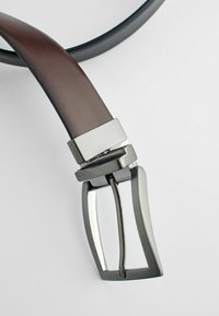 Leather belt with a dark brown smooth finish, featuring a silver metal buckle with a rectangular frame and matching hardware accents.