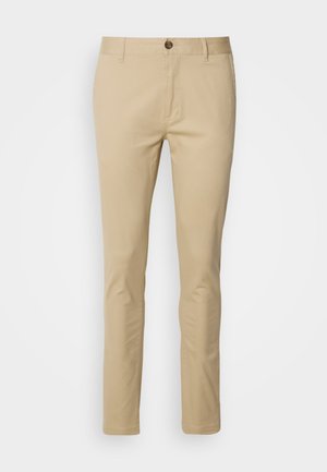 Beige chinos with a slim fit, made from cotton. Features a button closure, belt loops, and subtle stitching details on pockets.