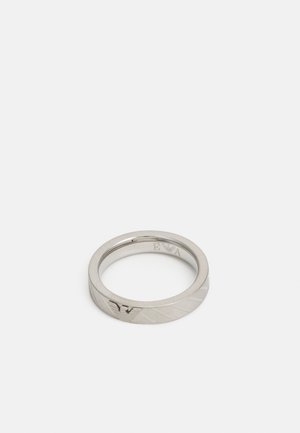 Silver metal ring with a smooth finish, featuring diagonal etched lines and an embossed logo inside. Simple, rounded band design.