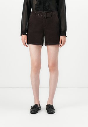 Brown corduroy shorts with a belted high waist, two side pockets, and a straight cut, paired with black lace-up shoes.