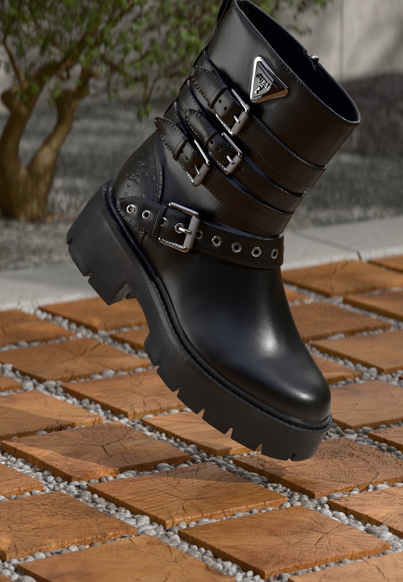 Sorte lær ankle boot med tre justerbare spennebånd, teksturerte detaljer, rund tå, chunky gummisåle og metallisk logo-detalj.