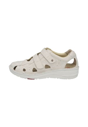 Light beige closed-toe sandal with adjustable straps, cushioned sole, and perforated sides for ventilation and comfort.