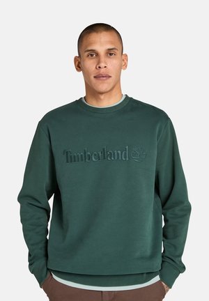 Donkergroen katoenen sweatshirt met geribde ronde hals, voorzien van het reliëf 'Timberland' logo en een boomgrafiek op de voorkant.