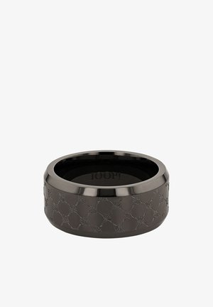 Bague en céramique noire avec un motif géométrique en relief, surface intérieure lisse et bord poli. Marque visible à l'intérieur.