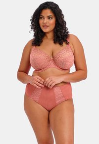 Ein BH und hohe Unterhosen in Korallenfarbe mit Leopardenmuster-Einsätzen, ausgestattet mit Lace-Details und einer glatten Textur.