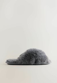 Gray fuzzy slipper with a rounded top, flat sole, and soft texture. The design features a plush exterior for comfort.