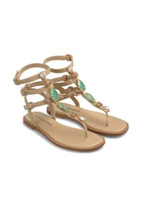 Płaskie sandały w kolorze beżowym z regulowanymi paseczkami na kostce, ozdobione zielonymi i różowymi kamieniami. Mają fason typu thong oraz textured sole.