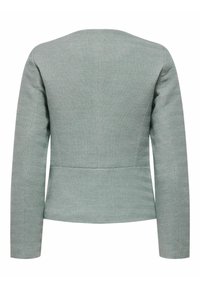 Grön strukturjacka med fiskbensmönster, långa ärmar och en figurnära design. Rent snitt och klassisk silhuett.