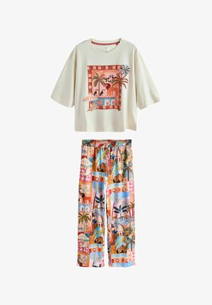 Cremefarbenes Kurzarmshirt mit tropischem Druck und passende bunte tropische Druckhose mit elastischem Bund und Kordelzug.