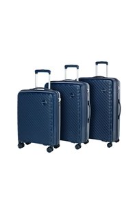Three navy blue hard-shell suitcases with diagonal ridges, extendable handles, and smooth spinner wheels, varying in size and height.